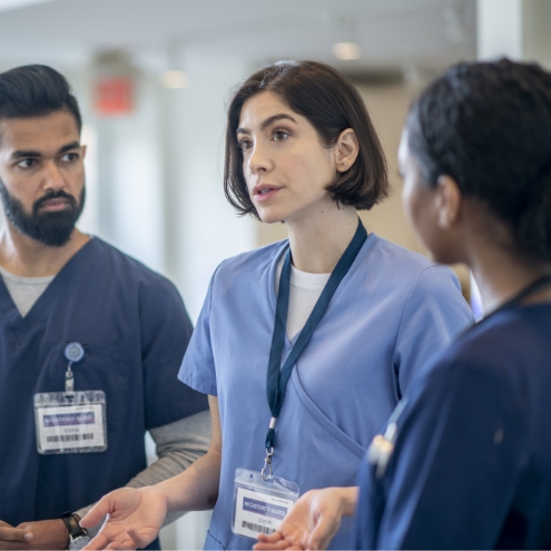 Three doctors in a professional conversation. 